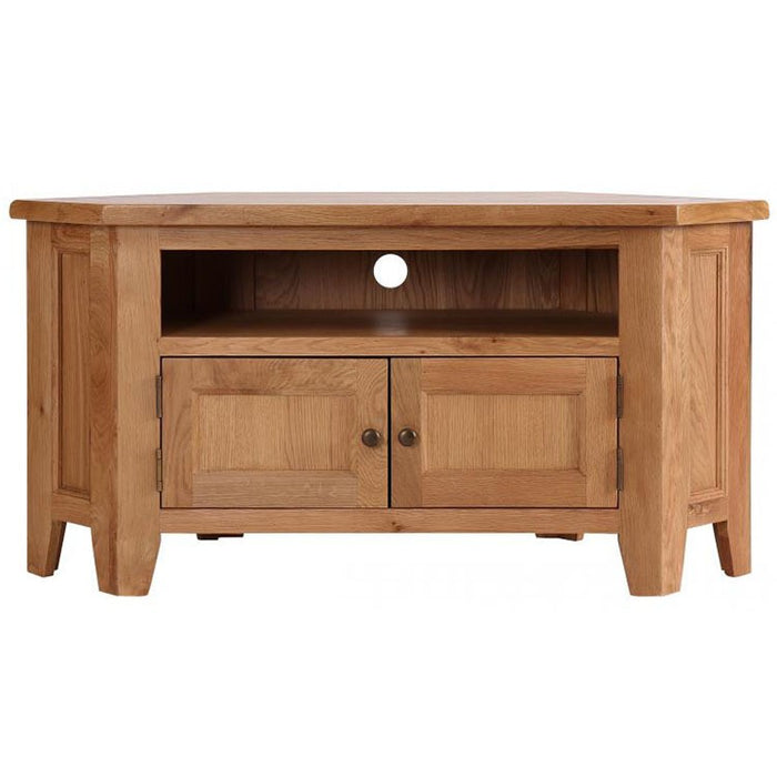 The Saoirse Corner Tv Unit is a premium solid oak stand with a natural finish, open shelf with cable hole, and two closed cabinet doors featuring round handles below.