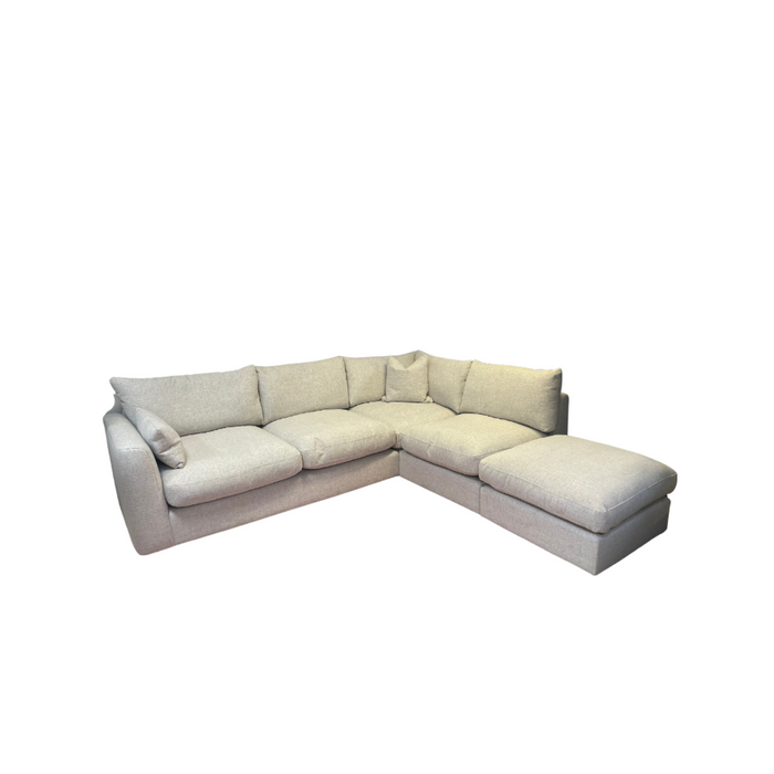 The Casablanca corner sofa is a modern, light gray L-shaped piece with deep seats, plush cushions, and an extended chaise lounge, upholstered in durable aqua clean fabric and photographed against a white background.