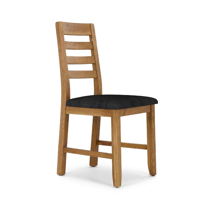 The Edson Dining Chair has a light brown oak frame, ladder-style backrest, and cushioned black PU seat, displayed at an angle on a white background.