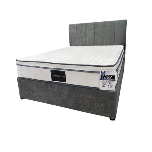 A gray colored standard divan bed set with a mattress on top and no visible storage base.