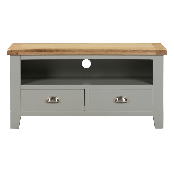 The Capri TV unit features a light grey wood finish, an oak top, two drawers with chrome cup handles, and an open shelf above with a circular cable hole at the back.