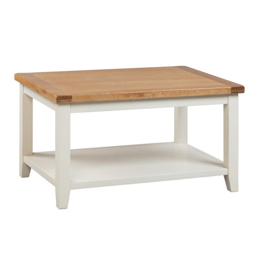 A rectangular Skellig coffee table with a cream painted base and natural oak tabletop, featuring a lower shelf.