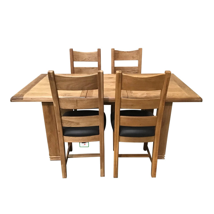 The Danube 1400 Ext with 4 Danube Chairs by vendor-unknown features a chunky solid oak rectangular dining table and four matching chairs with black cushioned seats, perfect for a charming country style dining room.