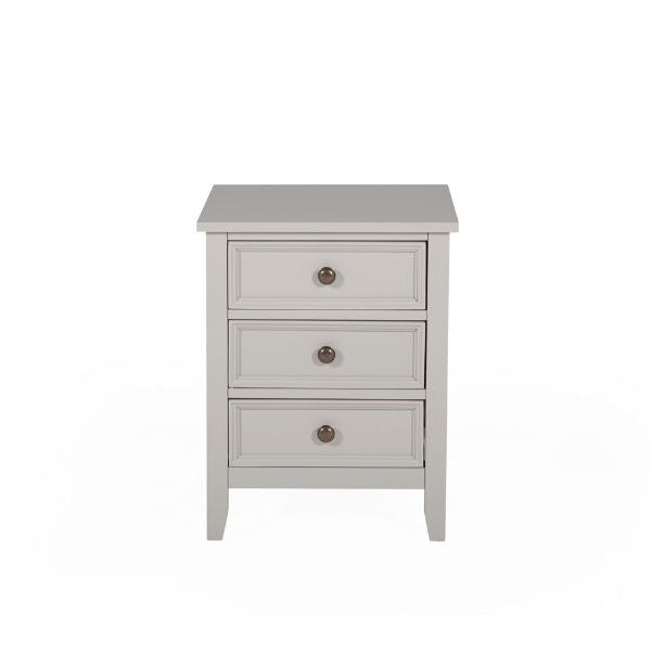 The Mila bedside locker by vendor-unknown is a small, light gray wooden nightstand with three drawers and round metal knobs, ideal for pairing with a painted grey bed or panelled headboard. Shown against a plain white background.