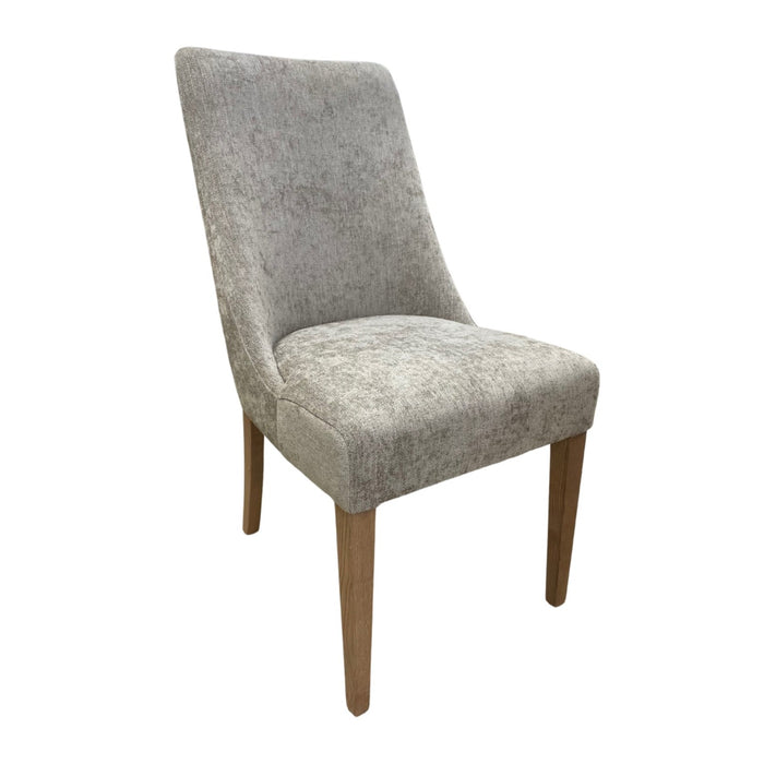 The Abby dining chair by vendor-unknown features light grey fabric and four solid wood legs, built to contract standard specifications, and is displayed on a white background.