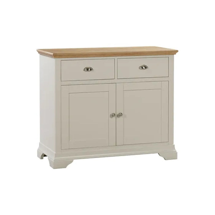 The Anglia Small Sideboard features a cream wooden finish, light wood top, two drawers with silver handles, two cabinet doors, and short feet—bringing contemporary two-tone style to your living room.