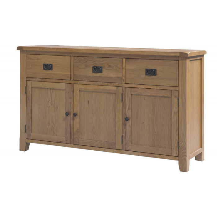 The Saoirse Large Sideboard is made of solid oak with a natural wood finish, featuring three top drawers and three lower cabinet doors. It has simple black metal handles and knobs, and a classic rectangular shape.
