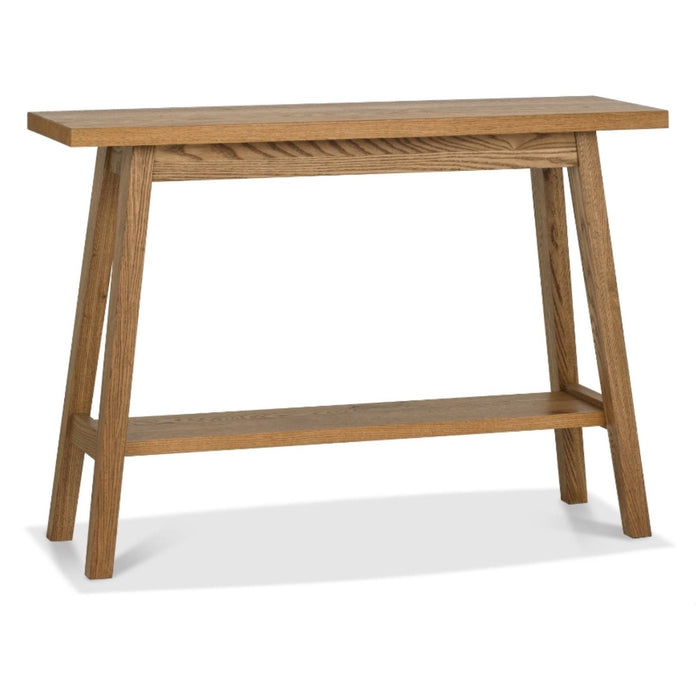The Camden Console Table features a rectangular oak top, four angled legs, and a lower storage shelf. Its natural wood finish and simple modern design pair perfectly with mid-century armchairs.
