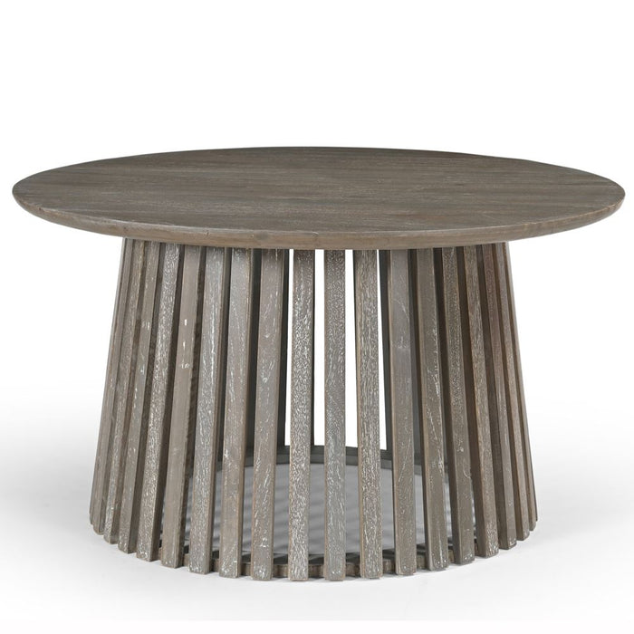 The Dalston Coffee Table features a smooth top and a flared cylindrical base made of evenly spaced vertical slats. Finished in stylish grey washed wood, it brings a modern touch to any living space.