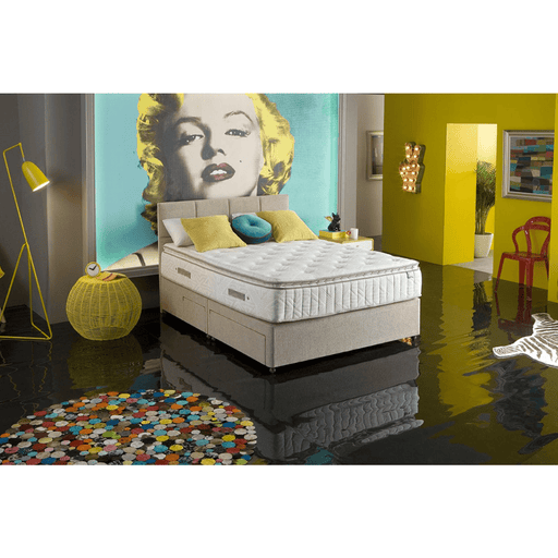 A King Koil mattress set in a bedroom setting, showcasing the mattress with pillow top layer, in a stylishly decorated room.