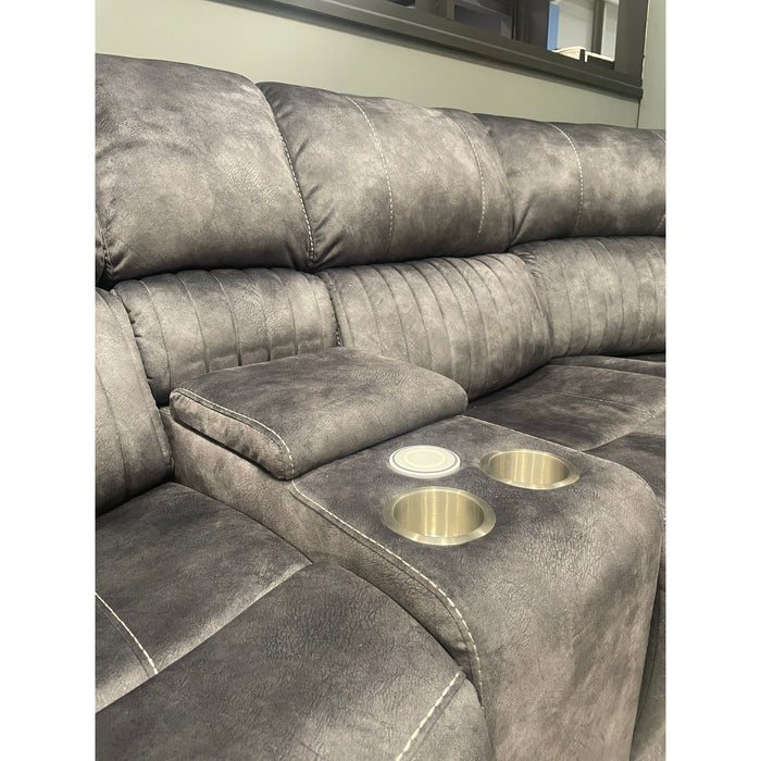 A close-up of the Boston corner group by vendor-unknown shows a gray textured fabric sofa with visible stitching. The built-in center console includes two cup holders, a wireless charging port, and a round white coaster.