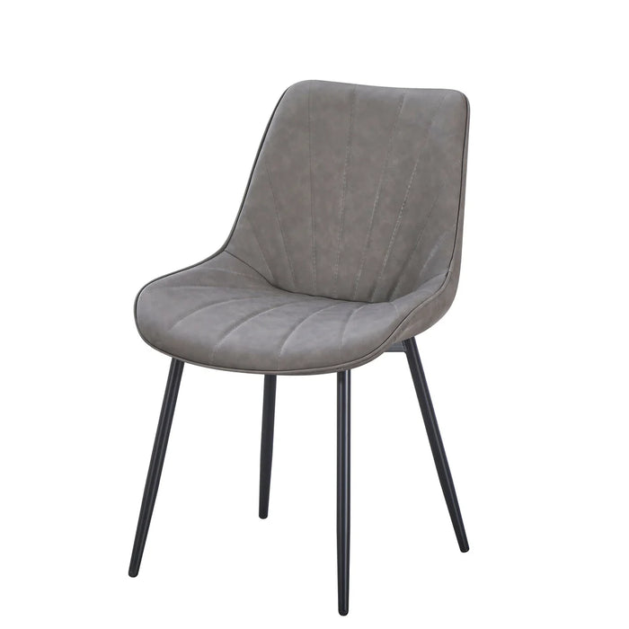 The Lilly Dining Chair features a gray faux leather upholstered seat and backrest with subtle vertical stitching, four black metal legs, and a gently curved design for added comfort.