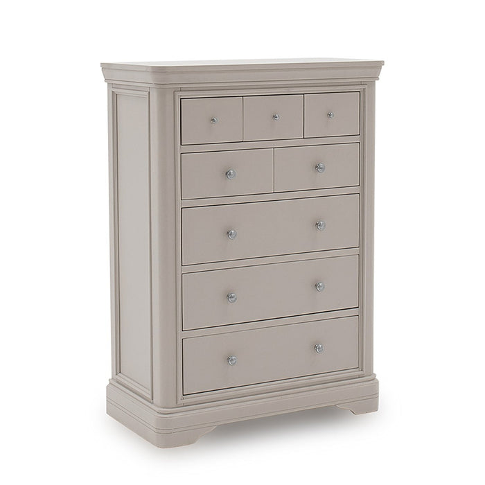 The Mabel Tall Chest by vendor-unknown is a tall, light gray wooden dresser with seven drawers, round silver knobs, and decorative molding—an ideal match for the contemporary Mabel Bedroom Collection.
