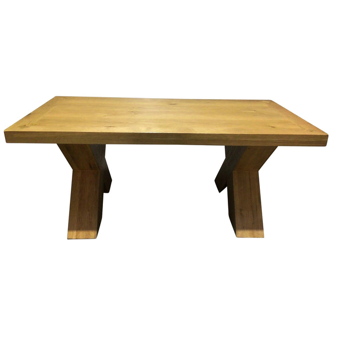 The Maximus Dining Table by vendor-unknown features a rectangular shape, natural finish, and two wide angled legs per side, showcasing a chunky country style against a white background.