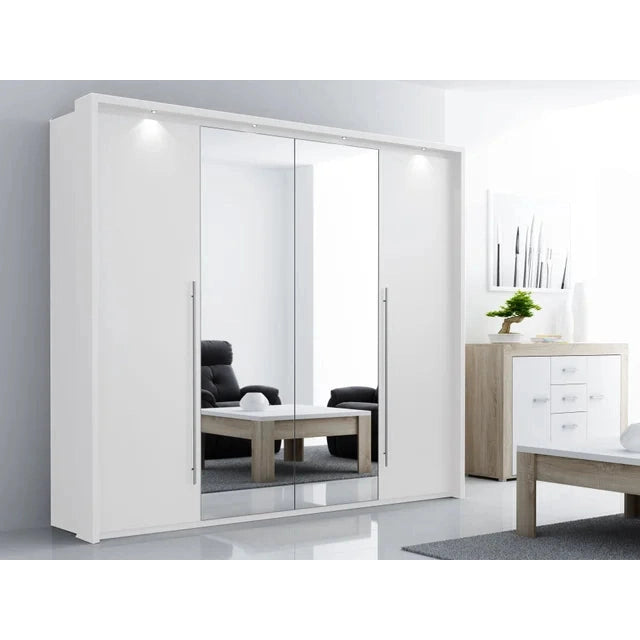 The Brema Sliderobe by vendor-unknown, a modern mirrored sliding door wardrobe with LED lighting, stands in a bright room reflecting a black chair, wooden coffee table, and a white chest of drawers with a plant and artwork above.