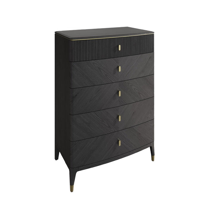 The Diletta Tall 5 Drawer Chest features a modern ribbed design with gold handles, subtle gold leg accents, and a textured top drawer. Tapered legs add elegance, all set against a white background for contemporary style.