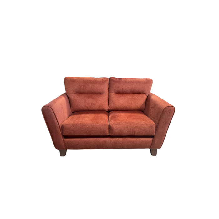 The vendor-unknown Cologne 3+2 is a two-seater sofa in reddish-brown fabric, featuring modern slim arms and dark retro-style legs, showcased against a white background.