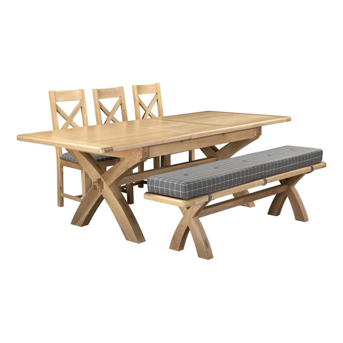 The Saoirse X Leg Table & Bench & 3 Chairs set includes a wooden extending table with chunky X legs, three matching X-back chairs, and a bench with a checkered gray cushion.