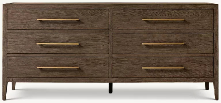 The Hampshire Wide Chest is a modern wooden dresser with a dark wood finish, six drawers featuring long slim gold handles, and short angled legs, perfect for adding style and storage to your bedroom.
