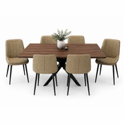 The Elson Dark Table + 6 Lilly Chairs set features a rectangular wooden top with black X legs and six beige upholstered chairs, accented by a white vase with green foliage and a small candle on a plain white background.
