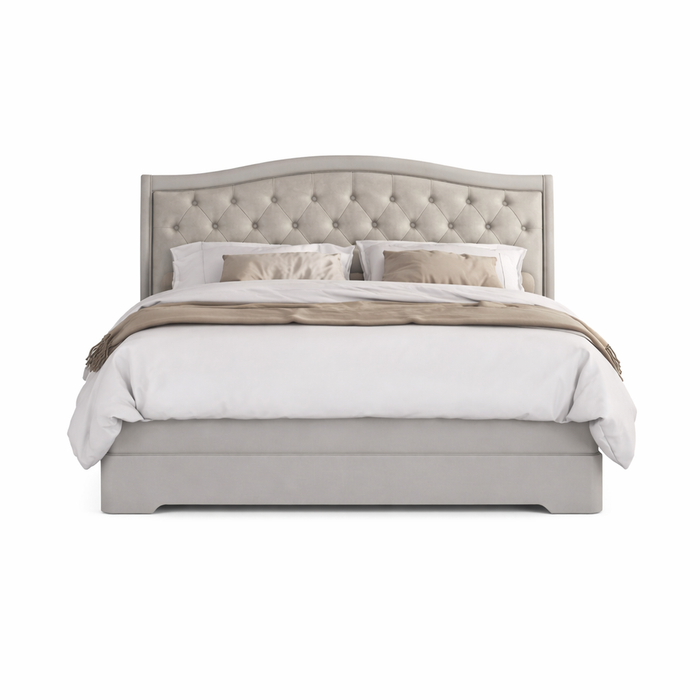 A neatly made bed with a light gray fabric headboard, white bedding, two pillows, and a throw blanket is styled on the Mabel Bedframe and viewed from the front against a white background.
