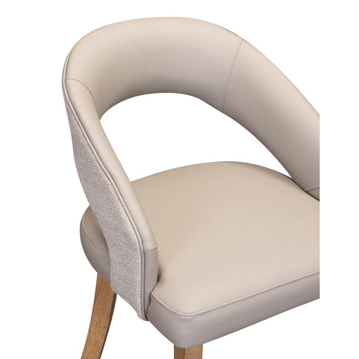 The Willow Dining Chair combines a curved, light beige upholstered back and seat, textured outer fabric, and light wooden legs—offering comfort and modern style for your dining space.