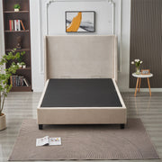 A modern bedroom showcases the Rivera Storage Bedframe in beige linen (mattress not included), offering smart storage. The space is accented with a patterned rug, side table with flowers, potted plant, bookshelf, and abstract art above the bed.