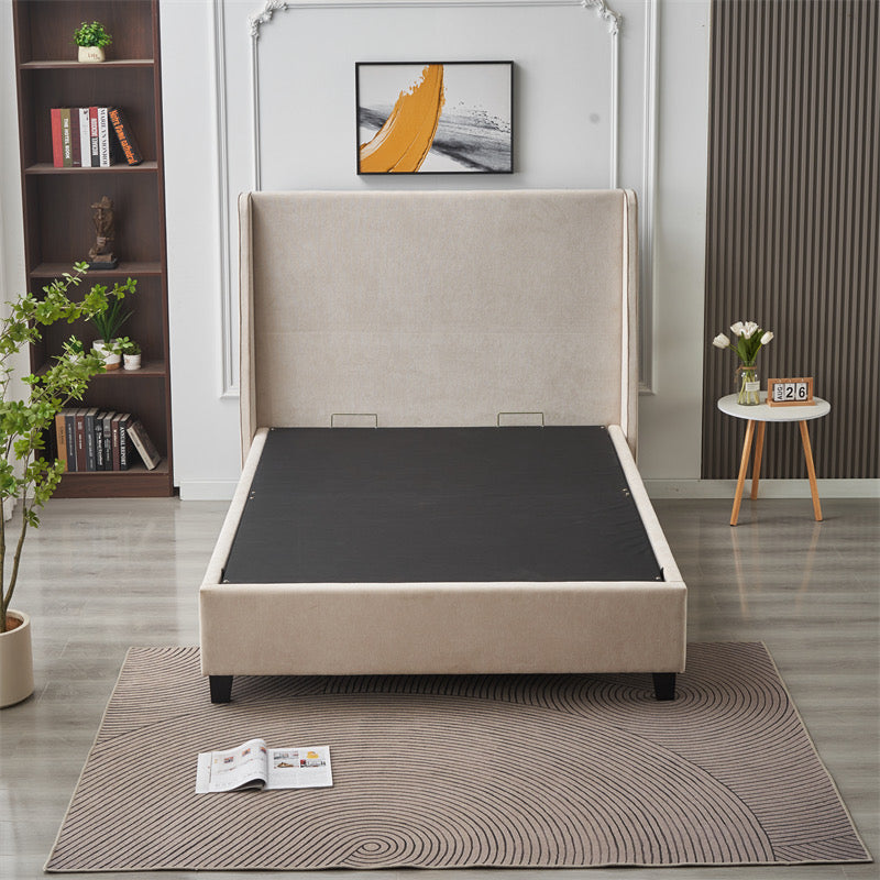 A modern bedroom showcases the Rivera Storage Bedframe in beige linen (mattress not included), offering smart storage. The space is accented with a patterned rug, side table with flowers, potted plant, bookshelf, and abstract art above the bed.