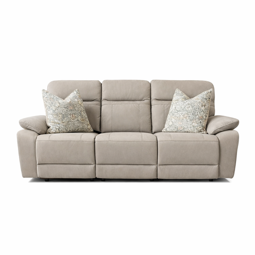 The Jude Recliner is a beige three-seat sofa with wide armrests, two patterned throw pillows, and plush washable microfiber cushions, shown against a white background.