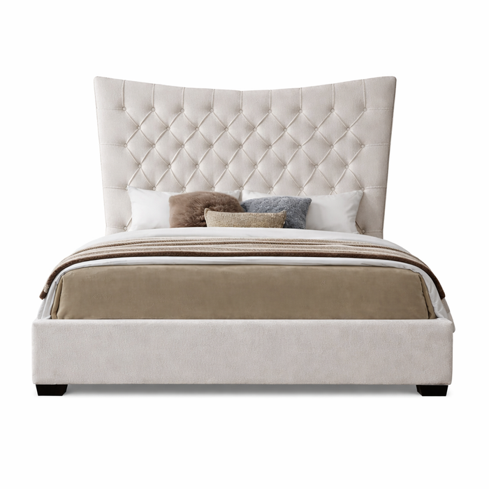 The Montreal Bedframe features a tall, tufted, cream headboard and is presented neatly made with neutral bedding and decorative pillows against a white background.
