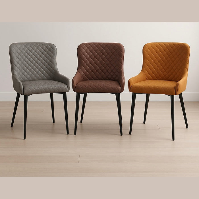 Three Diamond Dining Chairs with quilted patterns and slim black legs— in grey, brown, and mustard yellow—are side by side on a light wood floor, bringing modern style to a simple white wall.