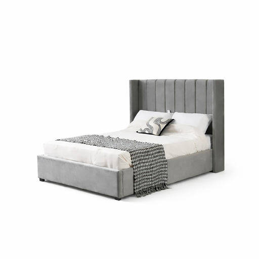 The Kildare Bedframe is a modern grey velvet bed with a tall, winged headboard and vertical stitching. Shown with white bedding, a decorative pillow, and a black-and-white throw at the foot against a plain white background.