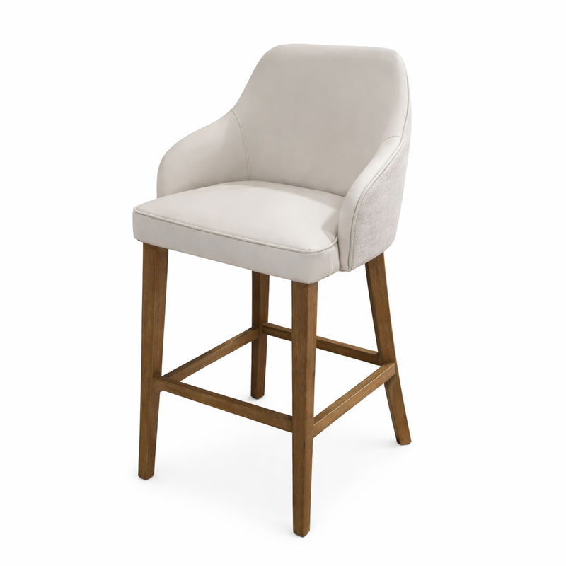 The Como Counter Stool is a modern stool with a light beige upholstered seat and backrest, curved armrests, and wooden legs with a footrest, shown against a white background.
