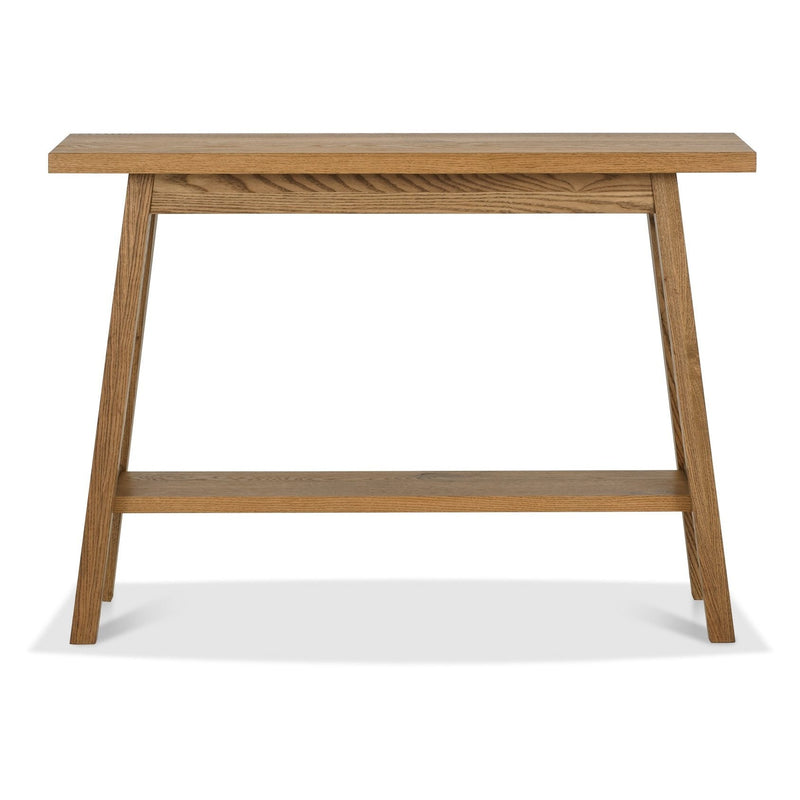 The Camden Console Table features a rectangular top, angled legs, and a lower shelf in light brown finish, and pairs beautifully with oak table tops from the Camden dining collection.