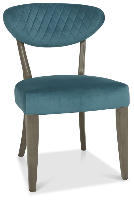 The Ellipse Fumed Oak Upholstered Chair features blue fabric and wooden legs, ideal for pairing with fumed oak furniture or introducing a touch of industrial style to any room.