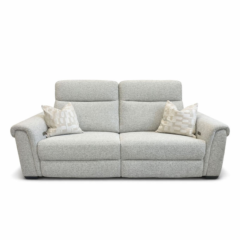 The Luna Electric Recliner is a light gray sofa with powered reclining, wide armrests, and two matching patterned cushions. Set against a white background, it combines modern style and comfortable design.