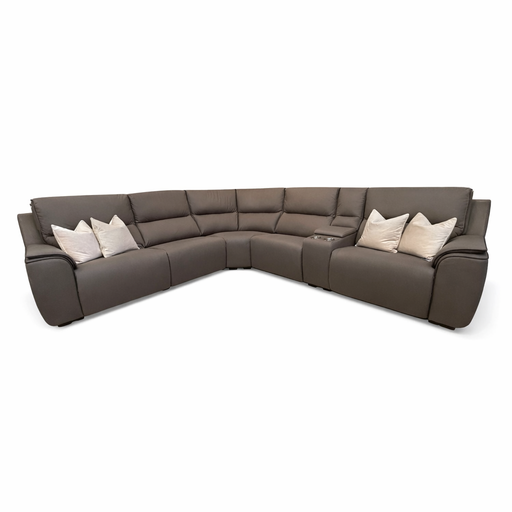 The Vegas Corner Group is a large, L-shaped sofa in dark gray wipeable fabric featuring a center cup holder console and six light-colored throw pillows, displayed against a plain white background.