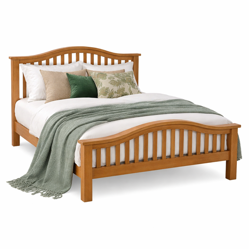 The Soairse Bedframe features solid oak construction with a curved slat headboard and footboard, dressed in white bedding, green and beige accent pillows, and a textured green throw for a classic, timeless bedroom look.