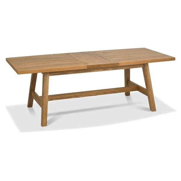 The Camden Dining Table is a rectangular wooden table with a natural finish, solid frame, sturdy legs, central support beam, and a smooth surface. It features a simple, modern design from the Camden Dining Range.