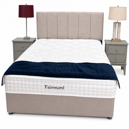 A beige Fairmont Divan Set - Special with stylish headboard, white mattress, dark blue blanket at the foot, and matching nightstands with lamps on either side, all set against a plain white background.