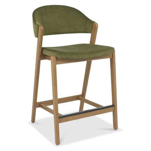 The Camden Counter Stool features light wooden legs, a green cushioned seat, a curved backrest, and a front metal footrest—blending comfort and vintage-inspired style in a modern retro design.