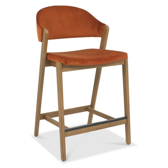 The Camden Counter Stool features a modern retro design with light wooden legs, an orange upholstered seat, and a curved backrest, shown against a white background.