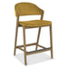The Camden Counter Stool features a mustard yellow cushioned seat and backrest, supported by a light wood frame and footrest, displayed on a white background.