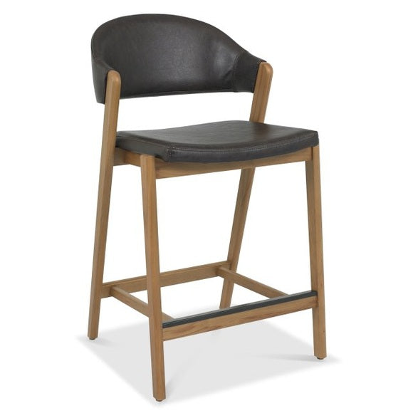 The Camden Counter Stool features a modern retro design with a wooden frame, angled legs, black cushioned seat, curved backrest, and a black front footrest bar for added comfort and style.