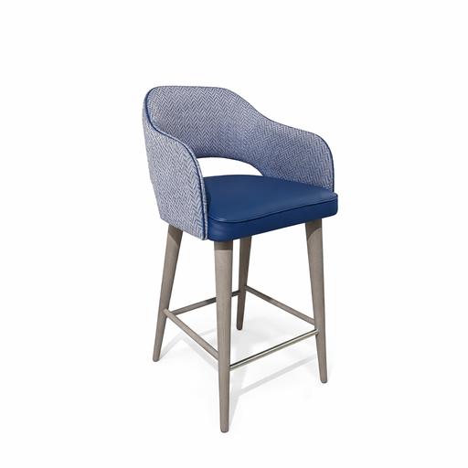 The Turim Counter Stool features a modern light wood frame, blue cushioned seat, curved backrest in textured blue and white upholstery, and a sleek metal footrest. This made-to-order stool combines comfort with contemporary style.