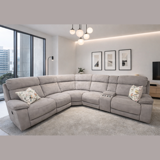 A modern living room featuring the Newbury Corner Group in easy-clean light gray fabric, floral cushions, a soft rug, minimalist decor, framed art, large windows, a TV, and round hanging lights.