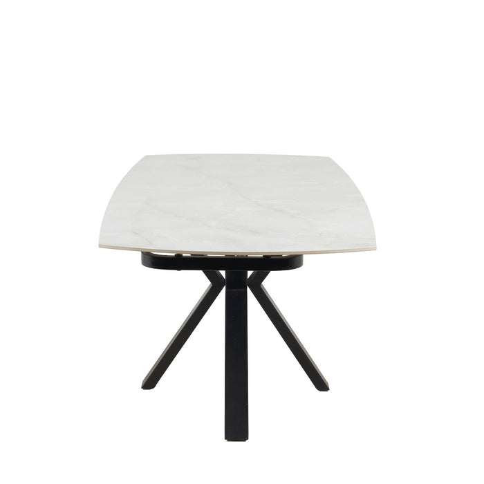 The Positano Swivel Dining Table showcases a modern rectangular design with black metal legs and a sleek white ceramic top, photographed from the short end and centered against a white background.