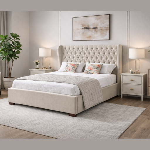 The Vienna Bedframe, featuring beige fabric and a winged headboard, sits next to a vibrant plant, making the room feel cozy and inviting.