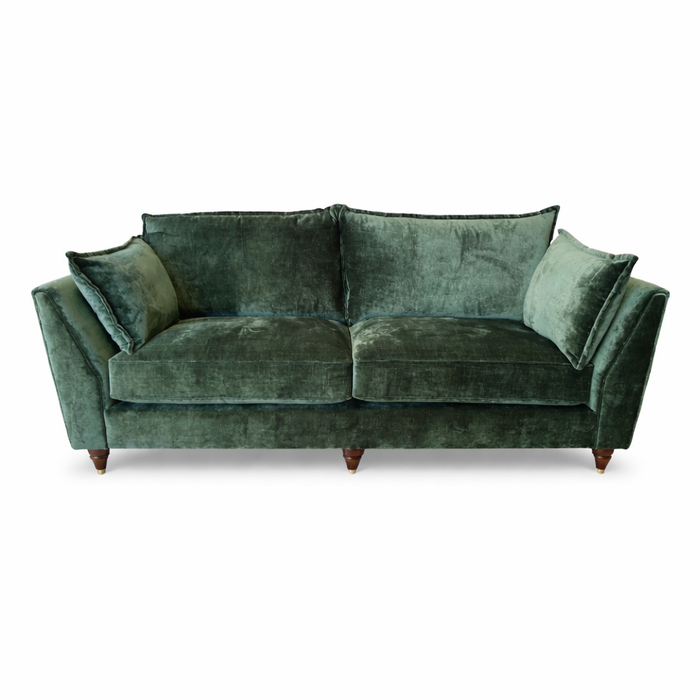 The Cleo Range green velvet sofa features plush cushions, deep seats, angled armrests, and wooden legs for an elegant look, shown front-facing against a white background.