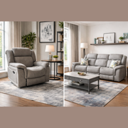 A modern living room featuring a light gray Reno Recliner Sofa in washable fabric, paired with a coffee table, floor lamp, side table, potted plant, wall art, and large windows with beige curtains on wood floors and neutral rugs.